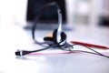 Call center service operator empty working place. Headset, glasses, keyboard and monitor at helpdesk employee workplace Royalty Free Stock Photo