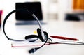 Call center service operator empty working place. Headset, glasses, keyboard and monitor at helpdesk employee workplace Royalty Free Stock Photo