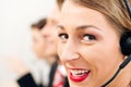 Call center team with headsets supporting customer Royalty Free Stock Photo