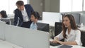 Call center young employee working with headset, Smiling customer support operator team at work surrounded Royalty Free Stock Photo