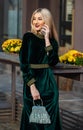 Call friend. Glamorous girl speaking phone. Fashion blog. Elegant woman in green velour dress. Mobile call