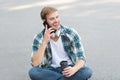 Call friend. Guy carefree student enjoy coffee outdoors. Life balance. Wellbeing and health. Having coffee break. Man Royalty Free Stock Photo