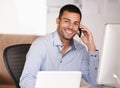 Call me if youre looking for someone with a good work ethic. Portrait of a smiling young man sitting at his desk and Royalty Free Stock Photo