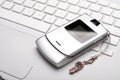 Call me! Mobile phone on a white laptop. Royalty Free Stock Photo