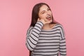 Call me! Portrait of beautiful happy flirtatious woman in striped sweatshirt winking playfully and making telephone gesture