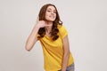 Call me. Portrait of happy playful teenager girl in yellow casual T-shirt doing talking on telephone Royalty Free Stock Photo