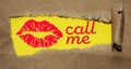 Call me text and a kiss under torn brown paper. Love date Romance concept