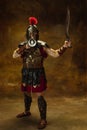 Historical portrait. Medieval person, young man, warrior or knight in war equipment isolated on vintage dark background