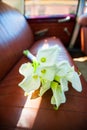 Callas festive bouquet on rear leather seats in vintage car