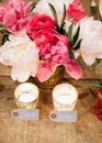 Calligraphed place cards for bride and groom on a wooden table