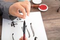 The calligrapher arranges the point of the brush with a brush in his hand Royalty Free Stock Photo