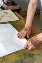 A calligrapher is folding rice paper and writing calligraphy preparations Royalty Free Stock Photo