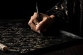 calligrapher in motion, writing phrase or quote on black background