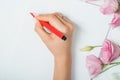 Calligrapher student practices in writing lettering with red marker on canvas. Creative artist freelancer working on