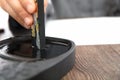 The calligrapher is studying ink on the inkstone with ink sticks in hand