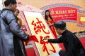 Calligraphers writing art letters for visitors in temple