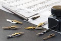 Calligraphy pen tips , flat tipped nib, ink and practice sheets on the table Royalty Free Stock Photo