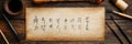 Ancient calligraphy tools and parchment placed on a wooden table showcasing intricate handwriting in an artistic setting Royalty Free Stock Photo