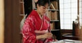 Calligraphy, writing and traditional Japanese woman in home for script, paper and documents. Creative, Asian culture and