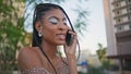 Calling fashionista talking mobile phone at summer city closeup. Happy girl call Royalty Free Stock Photo