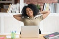 Calm African American businesswoman relaxing in comfortable office chair