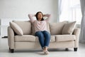 Calm african American woman relax daydream on cozy couch Royalty Free Stock Photo