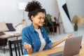 Calm African American young woman sitting workplace in the office and meditating taking break avoiding stressful job Royalty Free Stock Photo