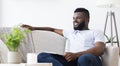 Calm african guy resting at home with digital tablet Royalty Free Stock Photo