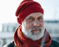 Calm aged man in red knitted hat. White bearde man portrait. Sailor man with grey haired beard Royalty Free Stock Photo