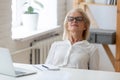 Calm aged woman relax in chair with eyes closed Royalty Free Stock Photo