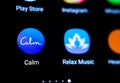 Calm app icon on the smartphone. Macro photo. App that helps to ease anxiety and stress