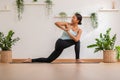 Calm of Asian woman in sportwear stretching muslce to warm up breathing and meditation with yoga at home.Healthy female doing yoga Royalty Free Stock Photo