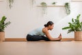 Calm of Asian woman in sportwear stretching muslce to warm up breathing and meditation with yoga at home.Healthy female doing yoga Royalty Free Stock Photo