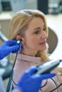 Calm attractive blonde middle-aged woman having her hearing checked