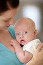 Calm, baby and portrait with mother holding newborn in home for bonding together. Infant, face and mom carrying curious Royalty Free Stock Photo