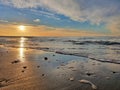 Calm Baltic Sea and sandy beach at sunset Close up Royalty Free Stock Photo