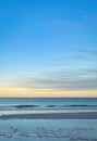Calm beach scene with pastel sunset/sunrise, and birds. Royalty Free Stock Photo