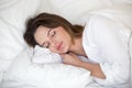 Calm pretty woman sleeping peacefully on white sheets in bed Royalty Free Stock Photo