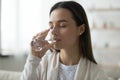 Calm beautiful young woman drinking fresh mineral water close up Royalty Free Stock Photo