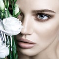 Calm Beauty Fashion Model Woman face. Portrait with white Rose flower.