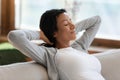 Calm biracial woman relax on sofa taking nap Royalty Free Stock Photo