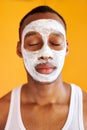 Calm black african man enjoy beauty procedures, skin care