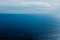 Calm blue sea without waves seen from a cliff with room for text Royalty Free Stock Photo