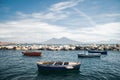 Calm blue Tyrrhenian Sea. View from the embankment of Naples to Mount Vesuvius volcano. Pleasure boats moored near the shore and Royalty Free Stock Photo