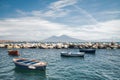 Calm blue Tyrrhenian Sea. View from the embankment of Naples to Mount Vesuvius volcano. Pleasure boats moored near the shore and Royalty Free Stock Photo