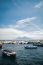 Calm blue Tyrrhenian Sea. View from the embankment of Naples to Mount Vesuvius volcano. Pleasure boats moored near the shore and Royalty Free Stock Photo