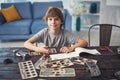 Calm boy smiling while showing his hobby at home Royalty Free Stock Photo