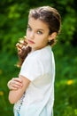 Calm brunette little girl in summer park