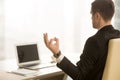 Calm businessman meditating in workplace, chin mudra, yoga at wo