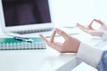 Calm businesswoman meditating at work, focus on female hands in mudra, close up view. Peaceful mindful employee Royalty Free Stock Photo